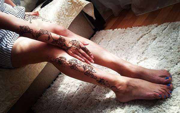 Tatuaje de henna en pierna y brazo